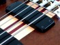 Fretless bass guitar in Imbuya close up of pickups